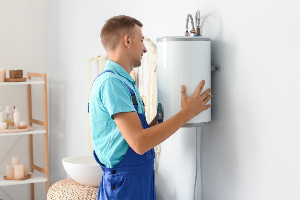 plumber carrying a water heater unit